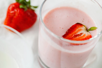 Homemade organic fresh raspberry smoothie with kefir(yogurt,ayran,lassi,milky product) for dieting breakfast in glass on white background close-up.Summer healthy fruit drink.Horizontal orientation