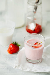 Homemade organic fresh raspberry smoothie with fermented kefir(yogurt,ayran,lassi,milky product) for dieting breakfast in glass on white background.Summer healthy fruit drink.Vertical orientation