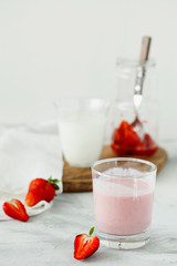 Homemade organic fresh raspberry smoothie with fermented kefir(yogurt,ayran,lassi,milky product) for dieting breakfast in glass on white background with copy space for text.Summer healthy fruit drink
