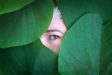 Woman behind the leaves