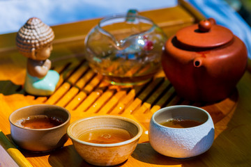 Tea ceremony. Teapot and bowls with Chinese tea on a wooden table