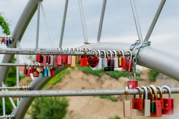 colorful love locks on a metal frame