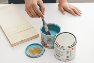 painting furniture, close-up hand with brush