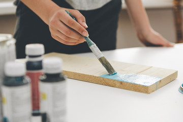 painting furniture, close-up hand with brush