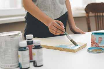 Fototapeta na wymiar painting furniture, close-up hand with brush