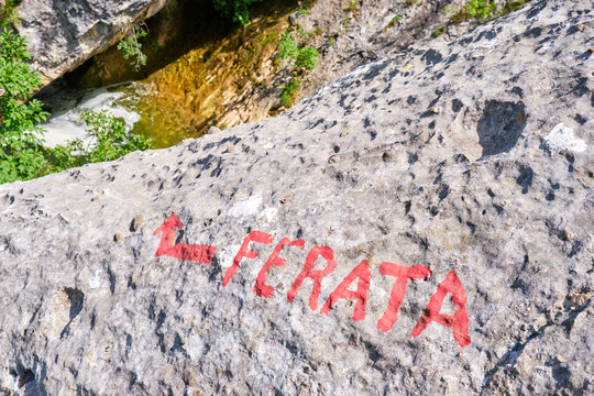 The word ferata - (via) ferrata misspelled - written in red on a rock in Cikola canyon, Croatia.
