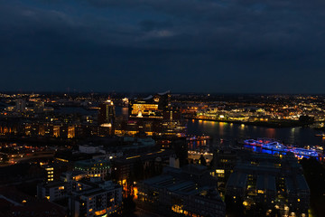 Aerial view of Hamburg, Germany in the evening with fireworks next to the new Elbphilharmony (Elphi) and illuminated boats