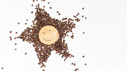 Coffee is a healthy, mood-enhancing drink. Star or sun from roasted coffee beans with a smile in the middle on a white background