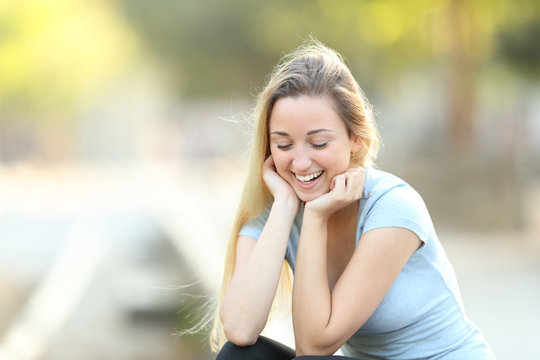 Candid teenage girl laughing looking down