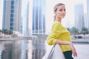 Obraz premium Sports lifestyle. Outdoor portrait of young woman on city embankment.