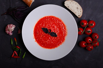 Vegetable soup, cherry tomatoes, and slices of bread