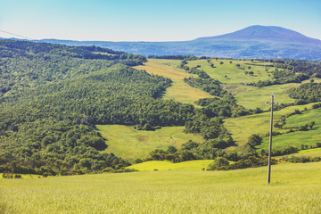 Obraz premium Beautiful landscape, spring nature. View from above of sunny fields on rolling hills in Tuscany, Italy