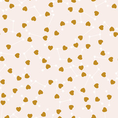Golden hearts and celestial elements in a seamless pattern design