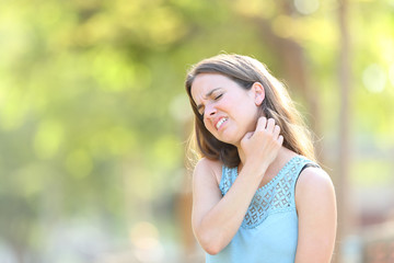 Woman suffering itching scratching neck