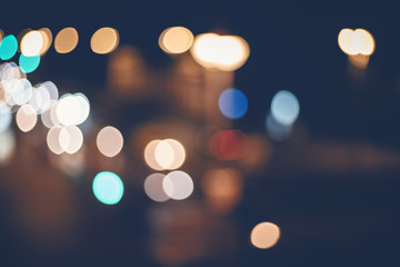 Retro toned blurred street lights, urban abstract background