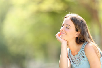 Naklejka premium Smiley woman meditating and relaxing in a forest