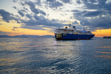 Travel by Greece. Beautiful sunset landscape with big ferry and sea wharf.