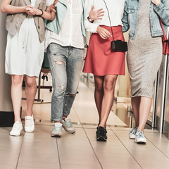 Fototapeta na wymiar Closeup photo of three modern stylish women walking in the store