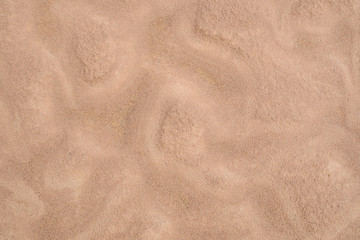 Fototapeta na wymiar Wet brown sand nature texture background