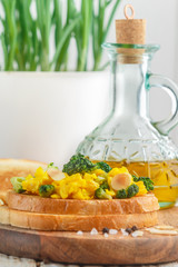 Bread toast with egg salad, broccoli and almond petals. Bruschetta. Delicious breakfast. Selective focus