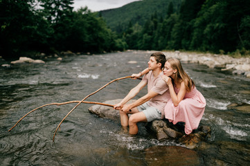 Funny couple fishing in the river.