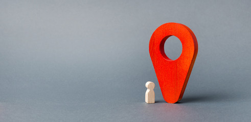 figurine of the child stands near a huge red pointer. tracking the location of the child in real...