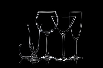 Glassware silhouettes on black.