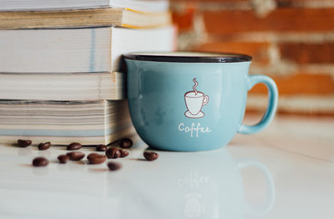 Open notebook and black coffee on white marble background.  Copy space