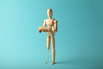 Wooden figure of man with artificial prosthetic leg. Amputee and disability concept.
