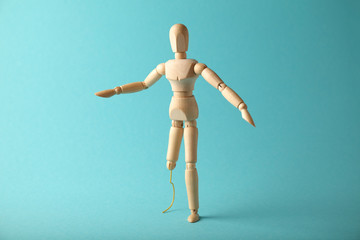 Wooden figure of man with artificial prosthetic leg. Amputee and disability concept.