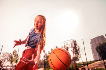 Tired young player improving her basketball technique