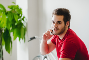 A boy speaks by phone at home