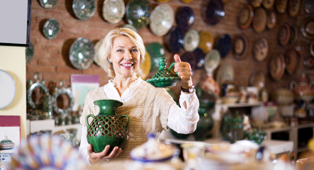 Naklejka premium Woman posing with ceramic tableware
