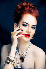Naklejka premium beauty stylish redhead woman with hairstyle and manicure wearing jewelry pearl close up