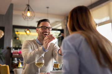 Couple tasting food at a restaurant