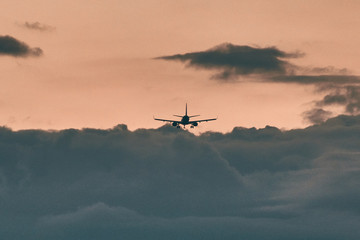 Fototapeta na wymiar Plane silhouette landing