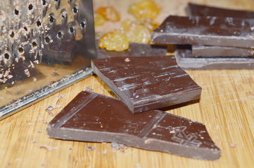 Pieces of chocolate and grater
