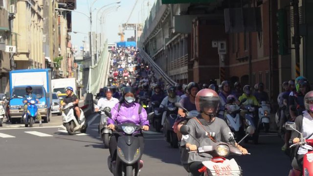Scooter waterfall in Taiwan ( 4K UHD time-lapse ). Traffic jam crowded of motorcycles at rush hour on ramp of Taipei Bridge, Cascade of scooters on Minquan West Road in Datong District, Taipei, Taiwan