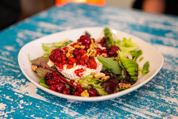 Food on the table. Different meals. Tasty looking plates with international food. Lasagna, pasta, pesto, tapas, salad and dumplings. Burgers and green. Yammy