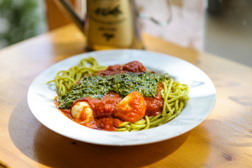 Food on the table. Different meals. Tasty looking plates with international food. Lasagna, pasta, pesto, tapas, salad and dumplings. Burgers and green. Yammy