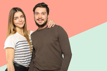 Happy couple embracing and looking at camera