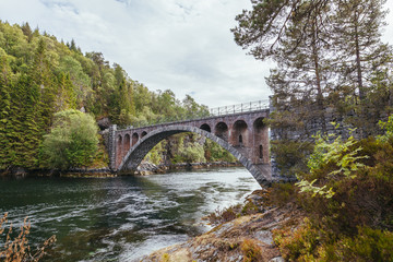 Old foot bridge over the river near alesund; norway