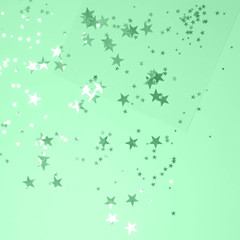 Festive mint background with silver stars.