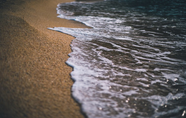 Closeup of sea wave on beach sand