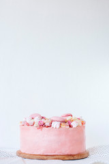 Pink cake. Decoration from sweets, macarons, marshmallows, white chocolate. Sweet birthday present. For girl.