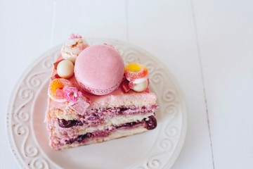 Pink cake. Decoration from sweets, macarons, marshmallows, white chocolate. Sweet birthday present. For girl. Red cocktail. Party.