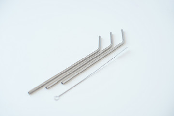 Lot of metal tubes for cocktails with schutkoy for cleaning isolated on white