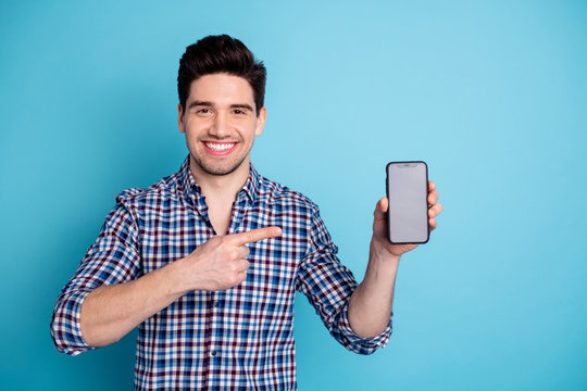 Photo portrait of confident positive optimistic cheerful with beaming toothy smile agent salesman trader freelancer businessman holding cellular in hand arm isolated pastel background
