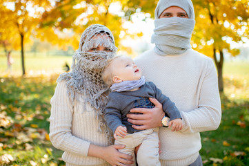 Strange family dressed like arabian people with their baby in hands. Arabian people wrapped in yashmak