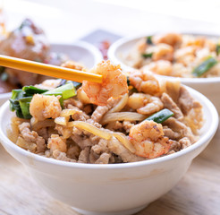 Braised shrimp over rice - Taiwan famous traditional street food. Soy-stewed prawn and sliced pork on cooked rice. Travel concept, copy space, close up